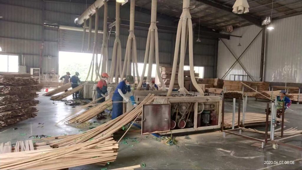 iDubuild workers operating machinery for bamboo product manufacturing